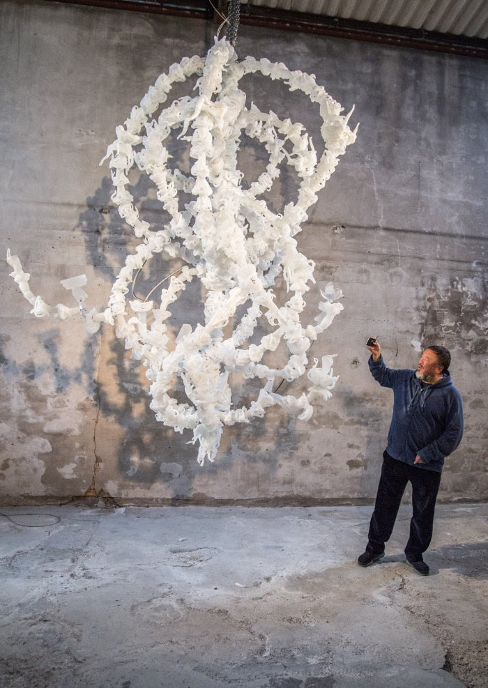 Ai Weiwei at the Berengo studio in Venice, next to his glass sculpture Blossom Chandelier. Photo by Karolina Sobel.