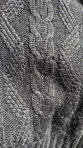 grey sweater with threads intertwined to give a more metallic effect