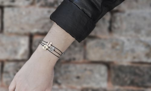 The three josa bracelet on the arm of a model showing the three colors and the three designs