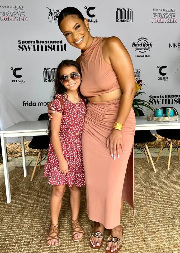 Sports Illustrated Swimsuit Model Kamie Crawford with a young fan